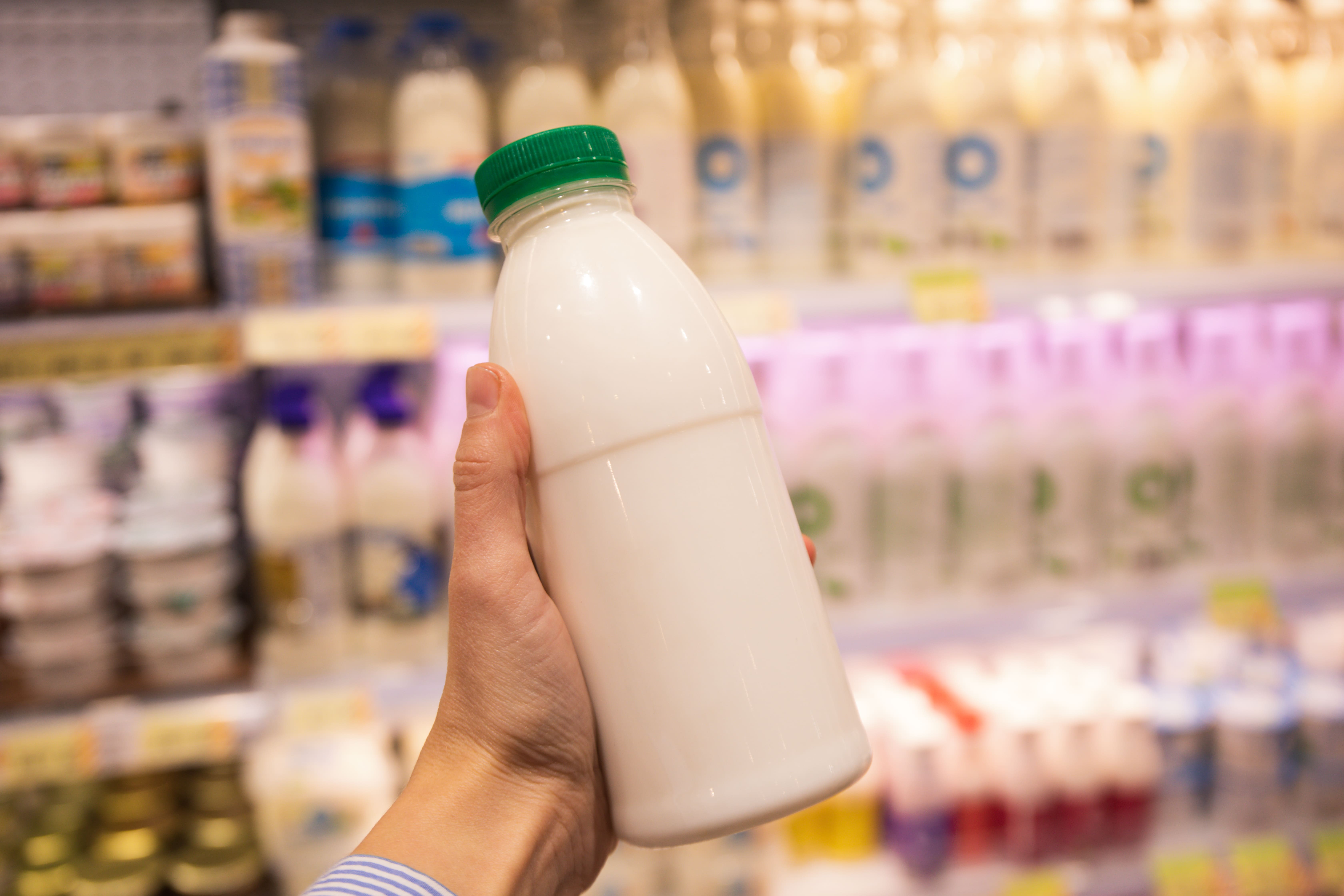 female-hand-holds-blank-bottle-dairy-product (1).jpg